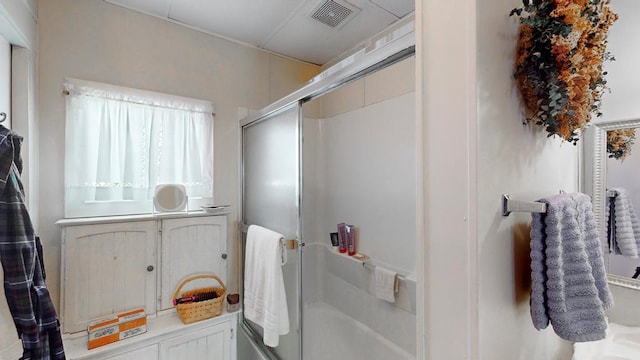 bathroom with a shower with shower door