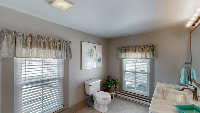 bathroom with vanity, a baseboard radiator, tile patterned floors, and toilet