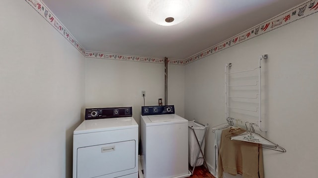 clothes washing area featuring separate washer and dryer