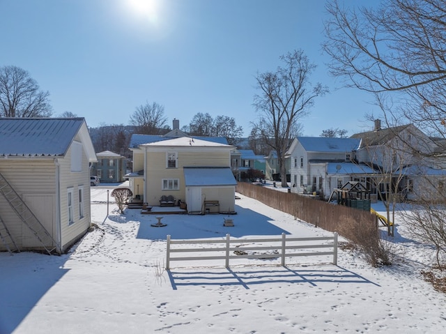 view of snow covered rear of property