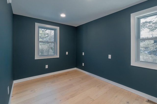 unfurnished room featuring light hardwood / wood-style floors