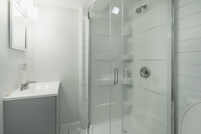 bathroom featuring vanity and a shower with shower door