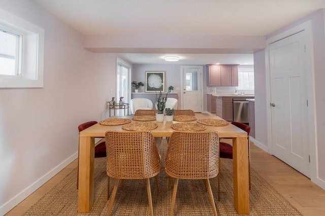 dining space with light hardwood / wood-style floors