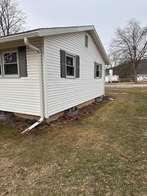 view of home's exterior with a yard