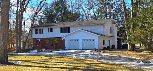 front facade with a garage and a front lawn