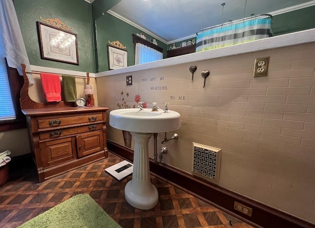 bathroom with walk in shower, parquet flooring, and ornamental molding