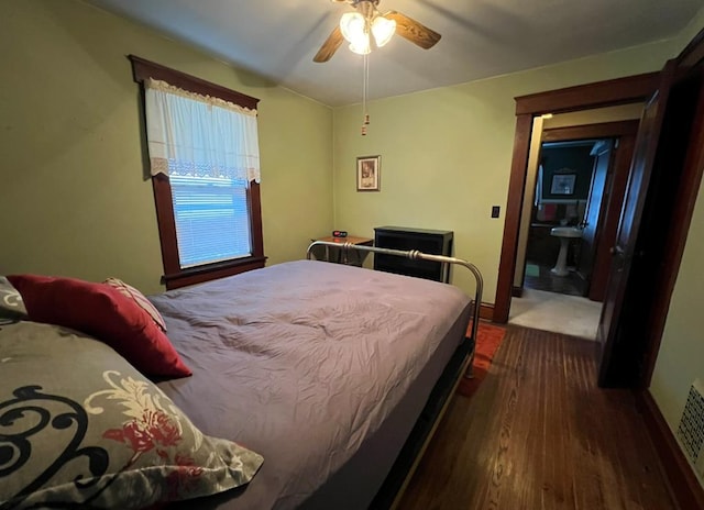 bedroom with dark hardwood / wood-style floors and ceiling fan