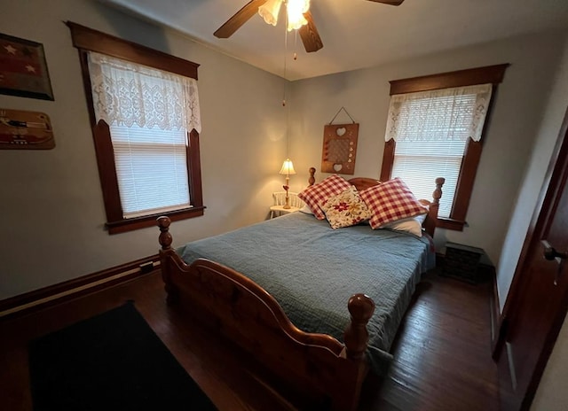 bedroom with ceiling fan and dark hardwood / wood-style flooring