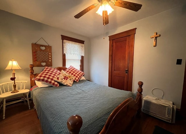 bedroom with a wall unit AC, dark hardwood / wood-style floors, and ceiling fan