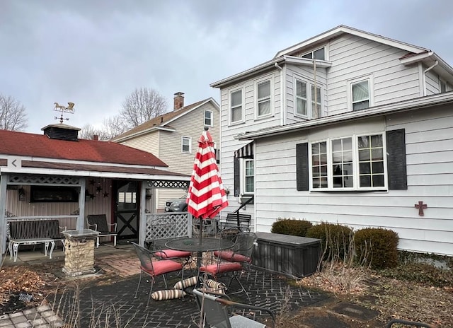 back of property with a patio