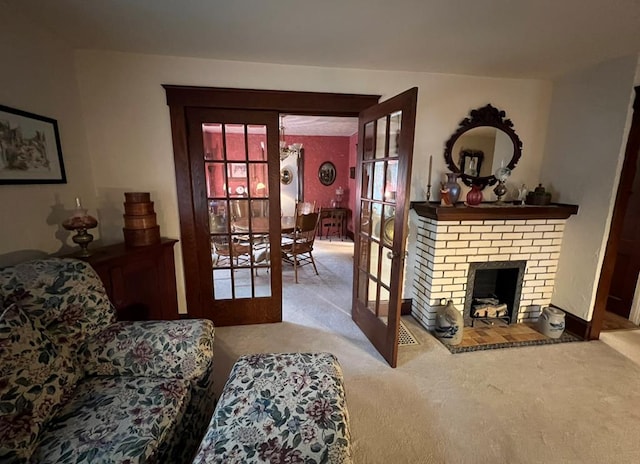 living room with light carpet, a fireplace, and french doors