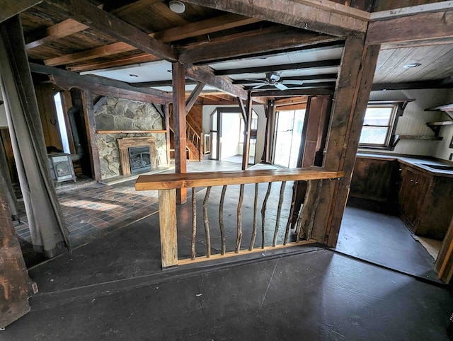 miscellaneous room with ceiling fan, a stone fireplace, and sink