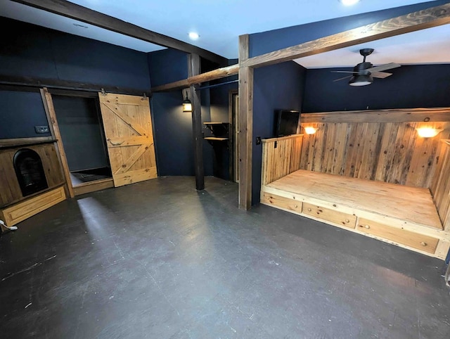 interior space featuring a barn door and ceiling fan