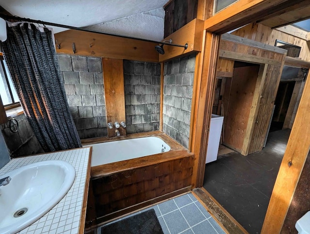 bathroom featuring shower / bathtub combination with curtain and sink