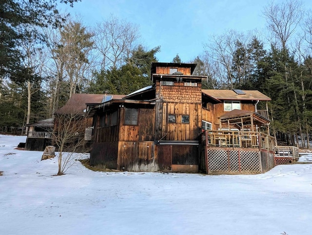 snow covered house with a deck