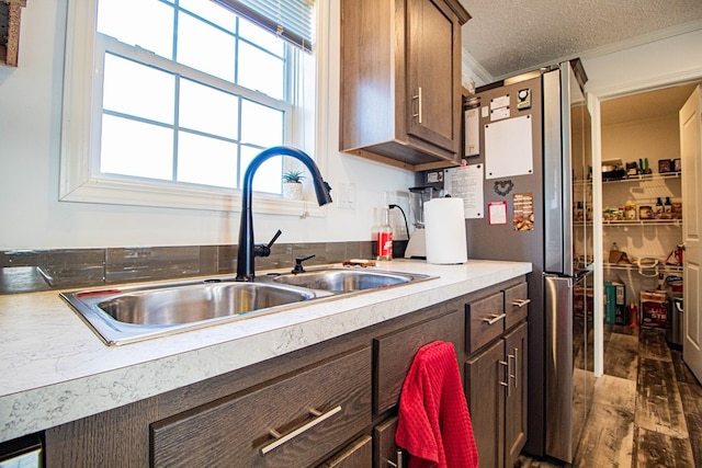 kitchen with sink, a textured ceiling, and dark hardwood / wood-style floors