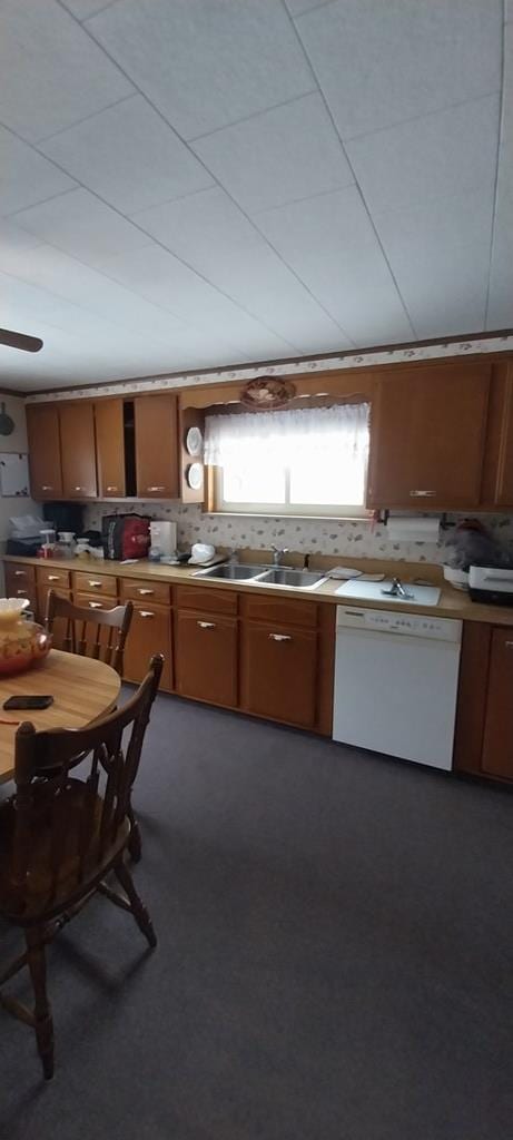 kitchen with ceiling fan, sink, and white dishwasher