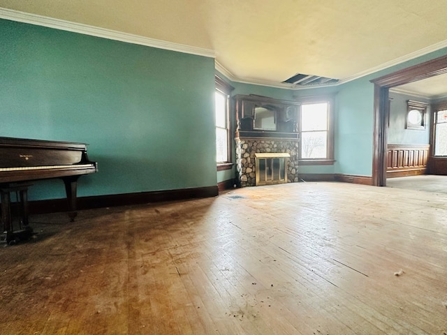 unfurnished living room featuring hardwood / wood-style floors, a fireplace, and ornamental molding