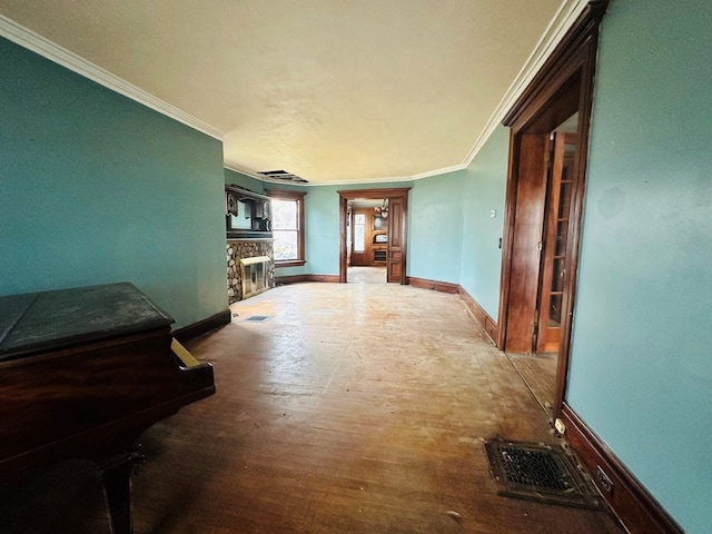 hallway with hardwood / wood-style flooring and ornamental molding