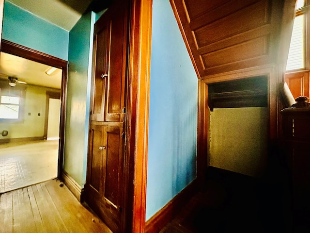 hallway with hardwood / wood-style flooring