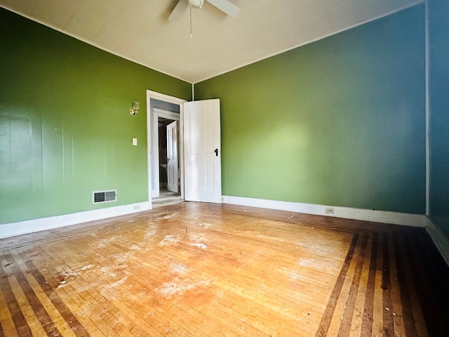 spare room featuring hardwood / wood-style floors and ceiling fan