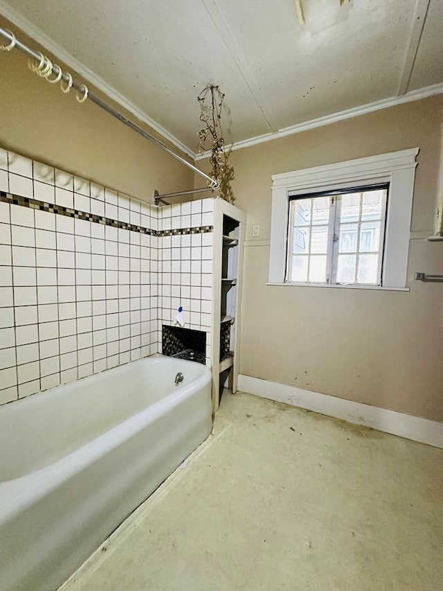 bathroom with tiled shower / bath, ornamental molding, and concrete flooring