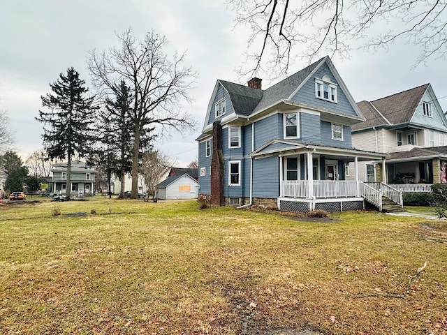 view of home's exterior with a yard and covered porch