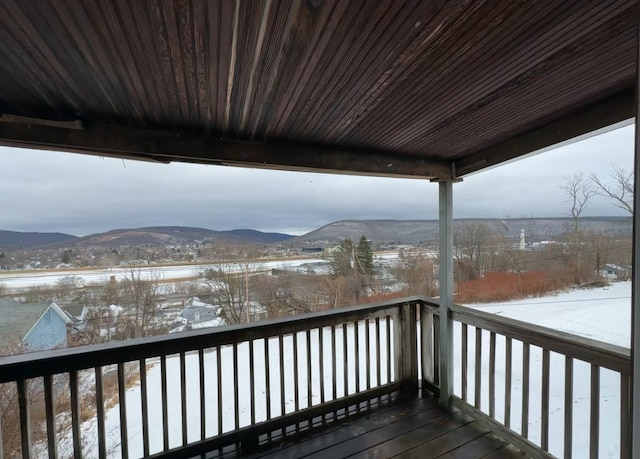 snow covered deck featuring a mountain view