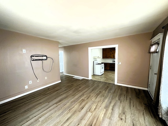 unfurnished room with wood-type flooring