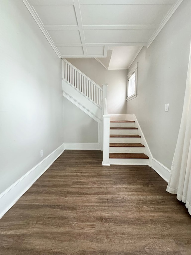 stairs featuring coffered ceiling, hardwood / wood-style floors, and crown molding