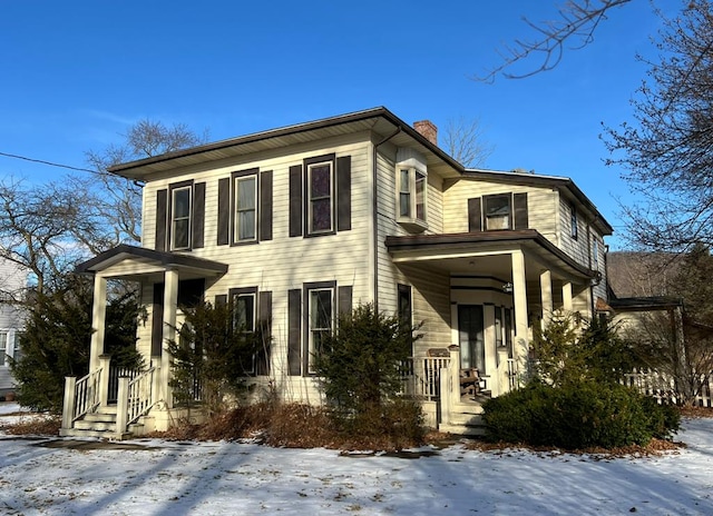 view of front facade with a chimney