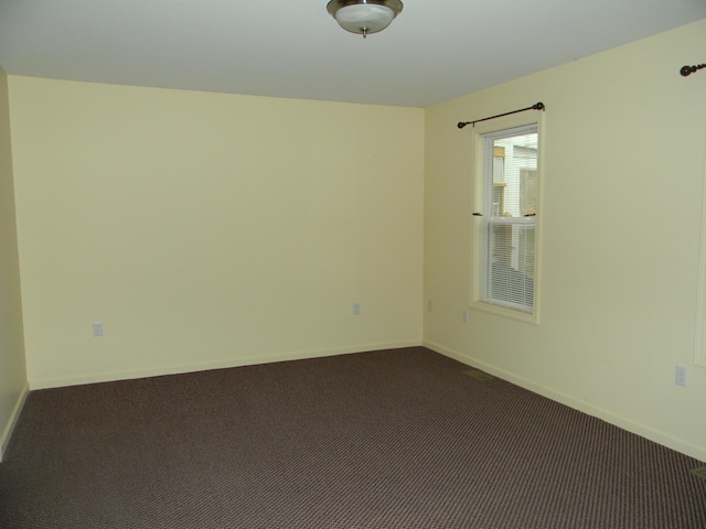 empty room with dark carpet