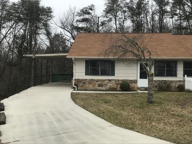 view of front facade with a front yard and a carport