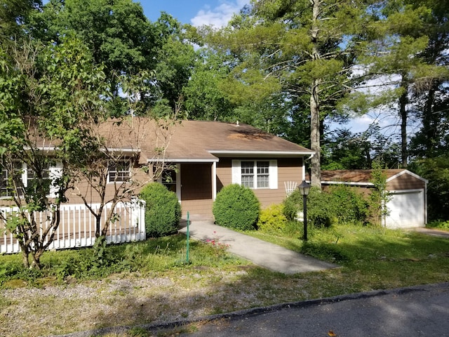 view of front facade with a garage and an outdoor structure