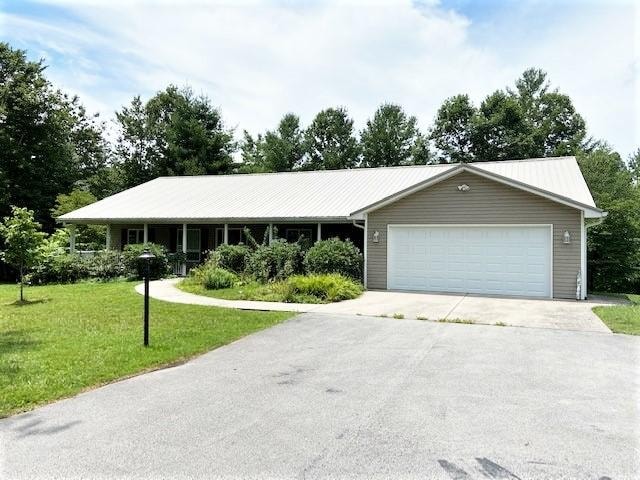 single story home featuring a front yard and a garage