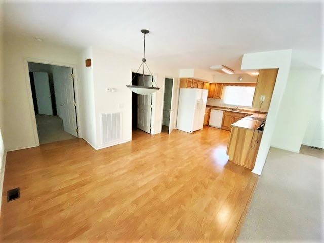 unfurnished living room featuring light wood-type flooring