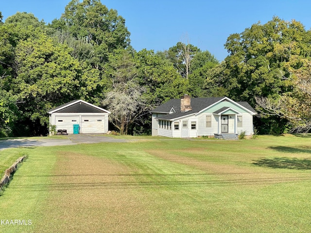 single story home with an outdoor structure, a front yard, and a garage