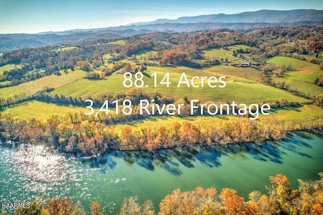 drone / aerial view featuring a water and mountain view