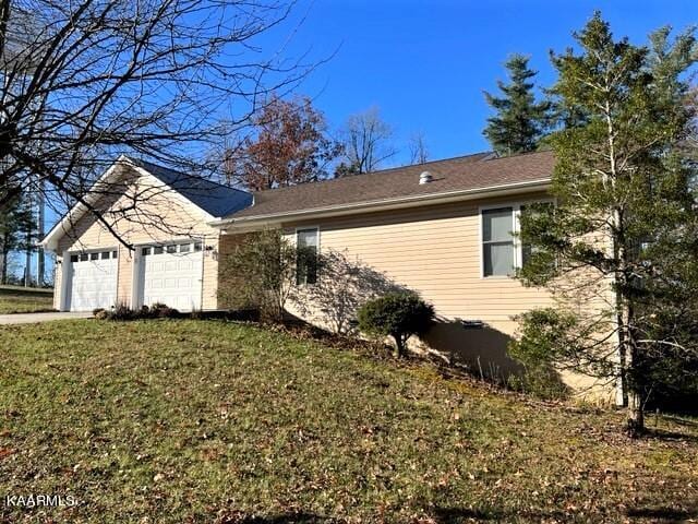 view of front of home with a front lawn and a garage