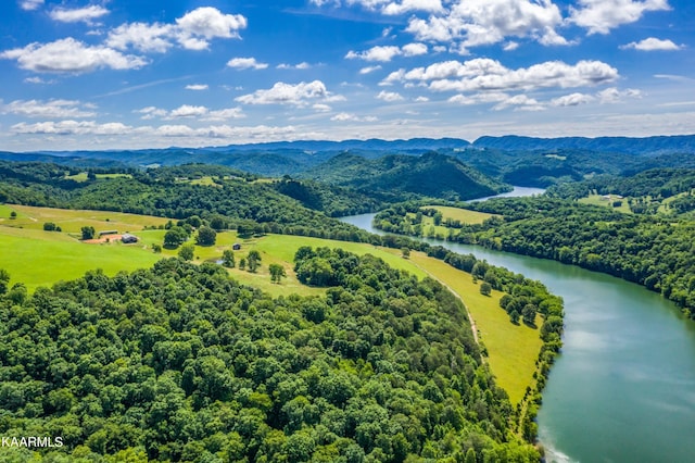 drone / aerial view featuring a water and mountain view