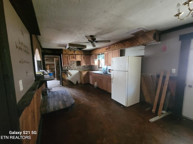 1359 Ditney Trl, Pioneer, TN 37847 - kitchen with freestanding refrigerator, a textured ceiling, ceiling fan, concrete floors, and brown cabinets