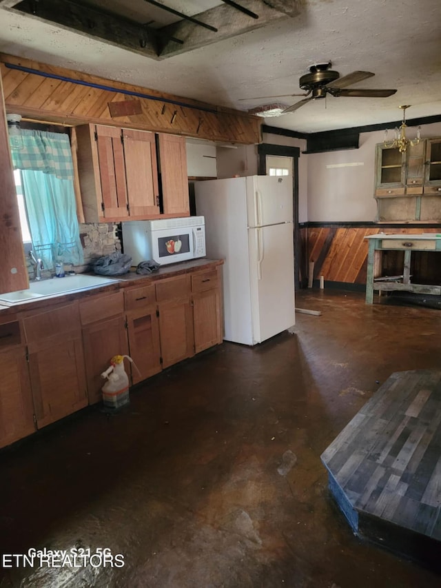 1359 Ditney Trl, Pioneer, TN 37847 - kitchen featuring white appliances, concrete floors, ceiling fan, and brown cabinetry