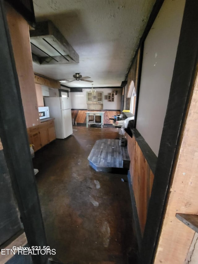 1359 Ditney Trl, Pioneer, TN 37847 - interior space featuring concrete floors, a ceiling fan, white microwave, and glass insert cabinets