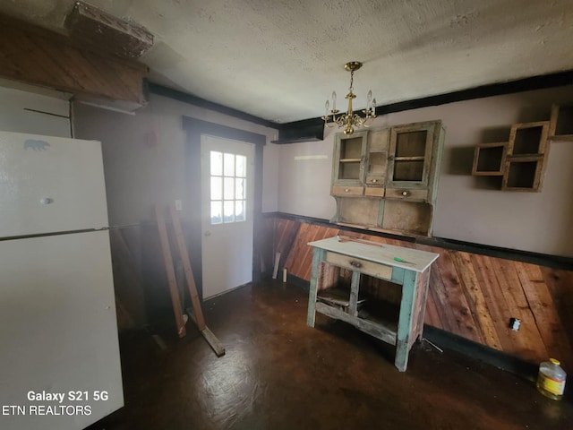 1359 Ditney Trl, Pioneer, TN 37847 - kitchen featuring freestanding refrigerator, wainscoting, concrete flooring, a textured ceiling, and wooden walls