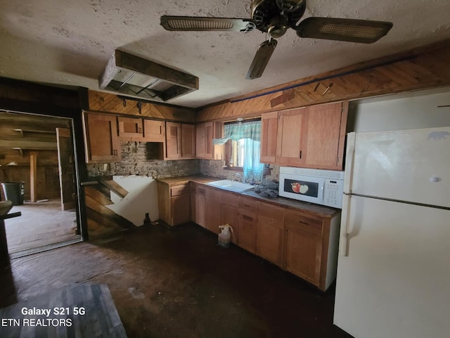 1359 Ditney Trl, Pioneer, TN 37847 - kitchen with white appliances, ceiling fan, wood walls, unfinished concrete floors, and a textured ceiling