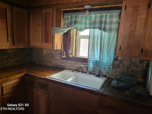 1359 Ditney Trl, Pioneer, TN 37847 - kitchen with backsplash, dark countertops, and brown cabinetry