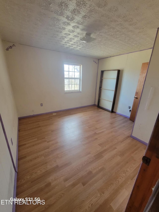 1359 Ditney Trl, Pioneer, TN 37847 - unfurnished room with light wood finished floors and a textured ceiling