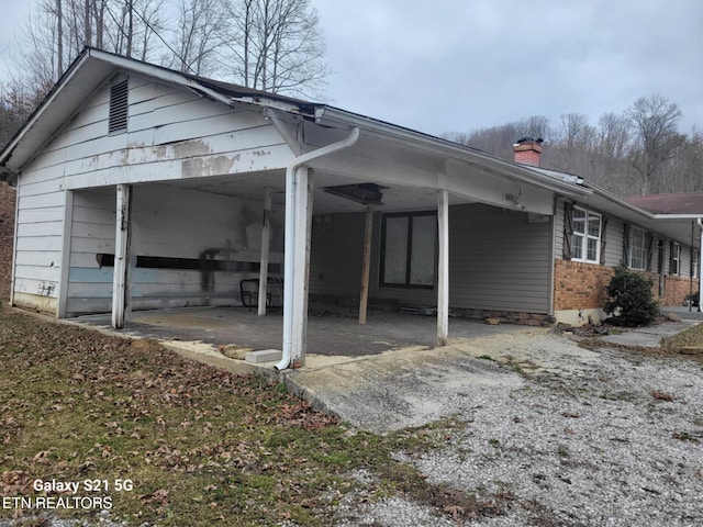 1359 Ditney Trl, Pioneer, TN 37847 - view of home's exterior with a chimney and brick siding