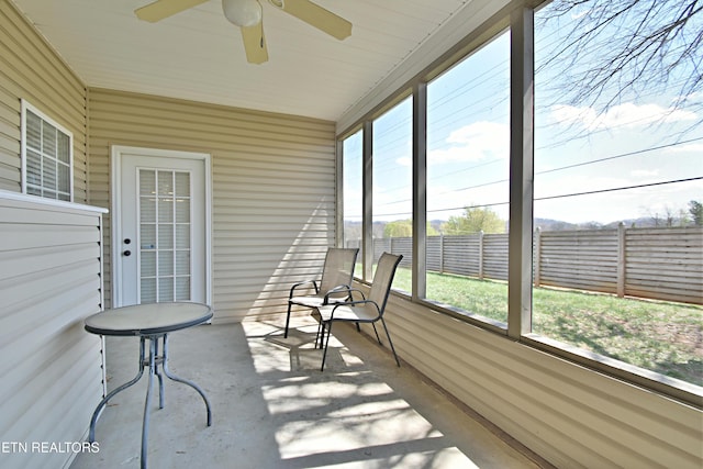 sunroom featuring ceiling fan