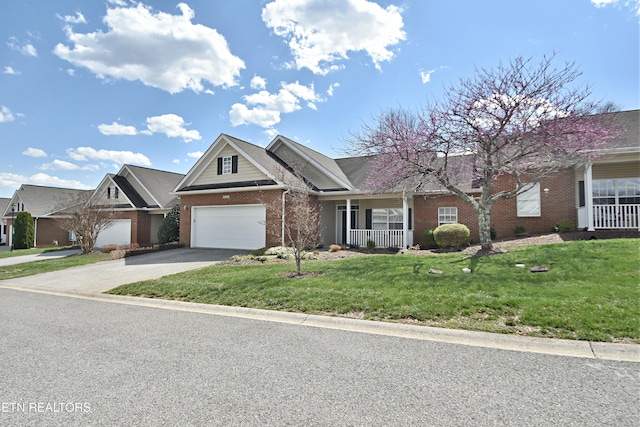 single story home with covered porch, a front lawn, concrete driveway, and brick siding